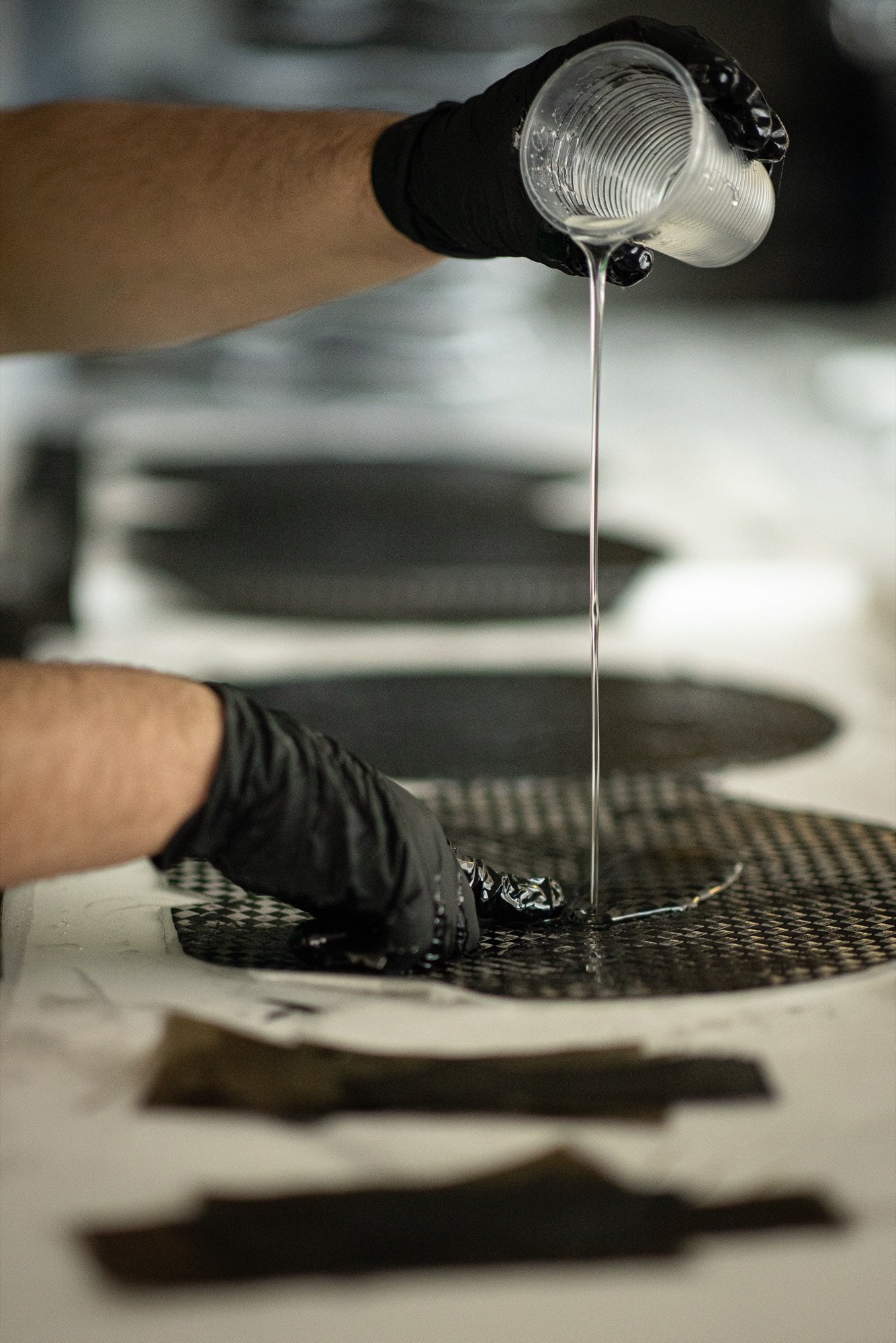 Resin being applied to carbon fibre at Padelsmith
